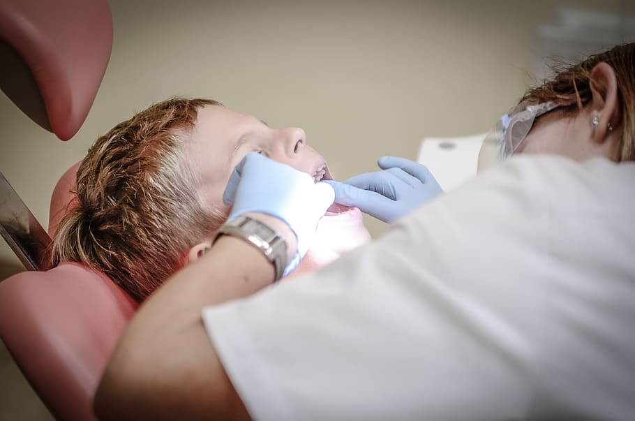 Hulme Court Dental and Implant Centre Dental Services - Dental Examination and Cleaning Boy Having Dental Checkup